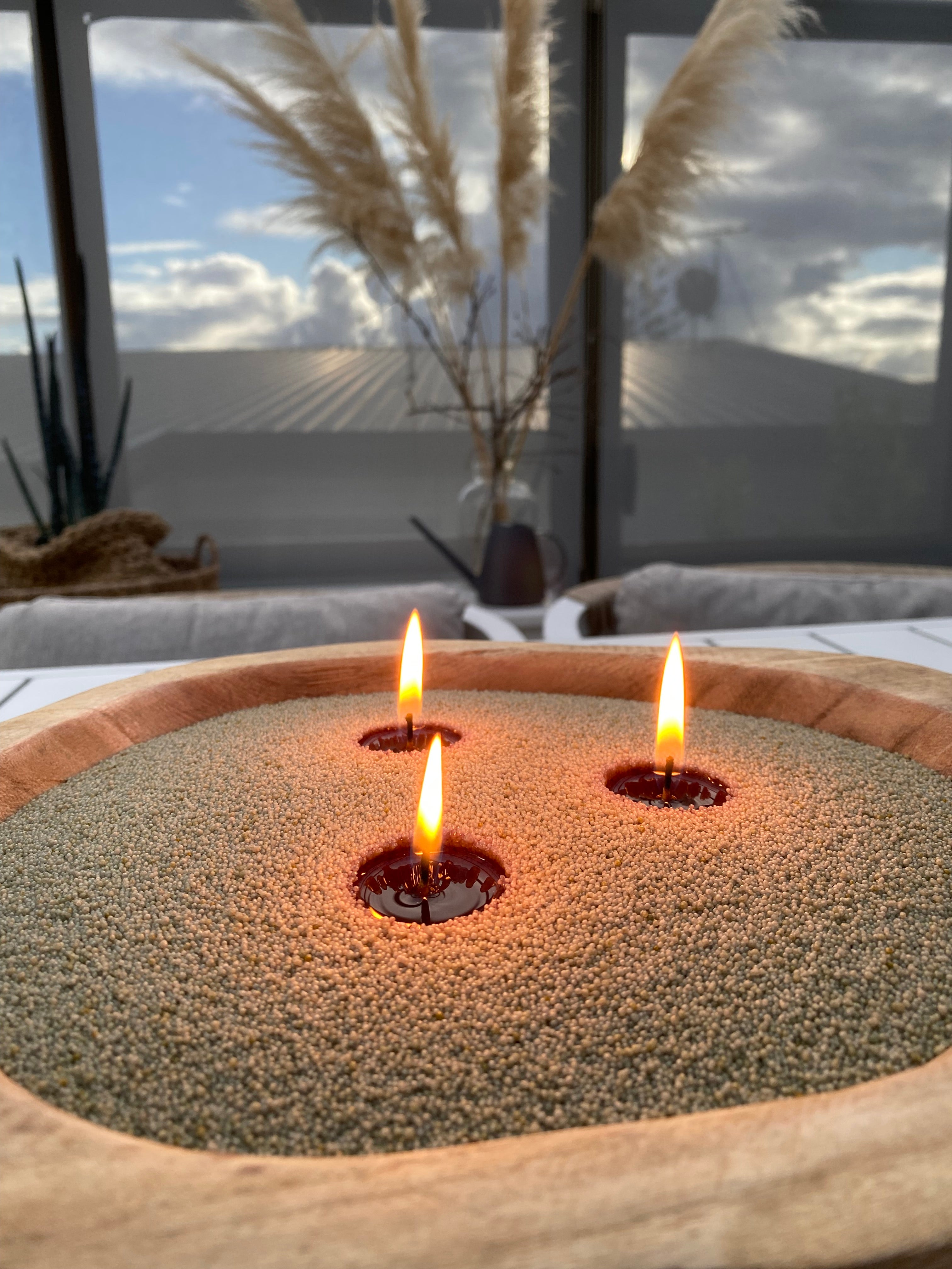 Wooden vessel with Akari Olive green sand wax. Customised with three wicks. 