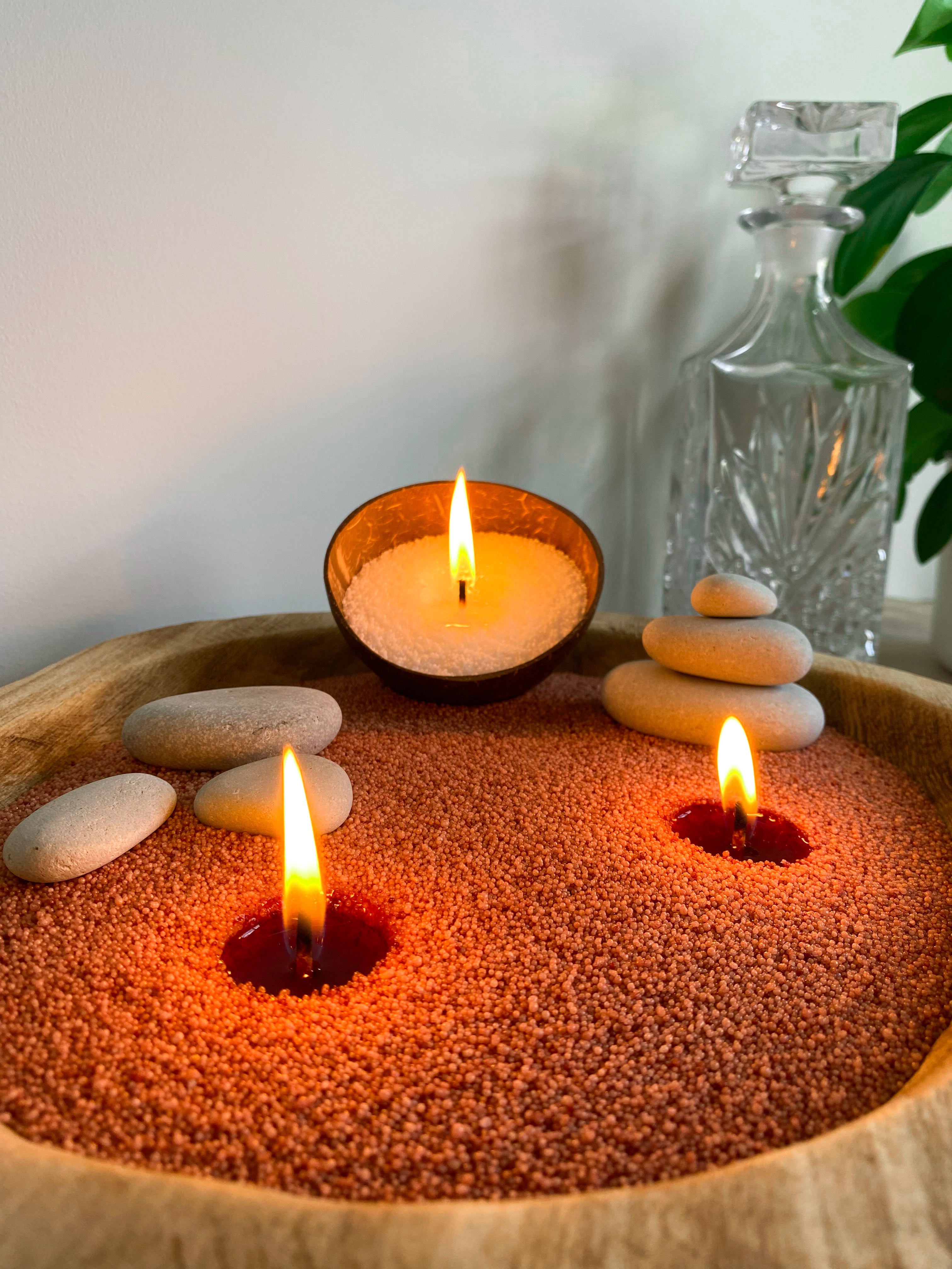 Customisable candles with earthy rocks and coconut shell. Unique sandwax that brings your creation to life