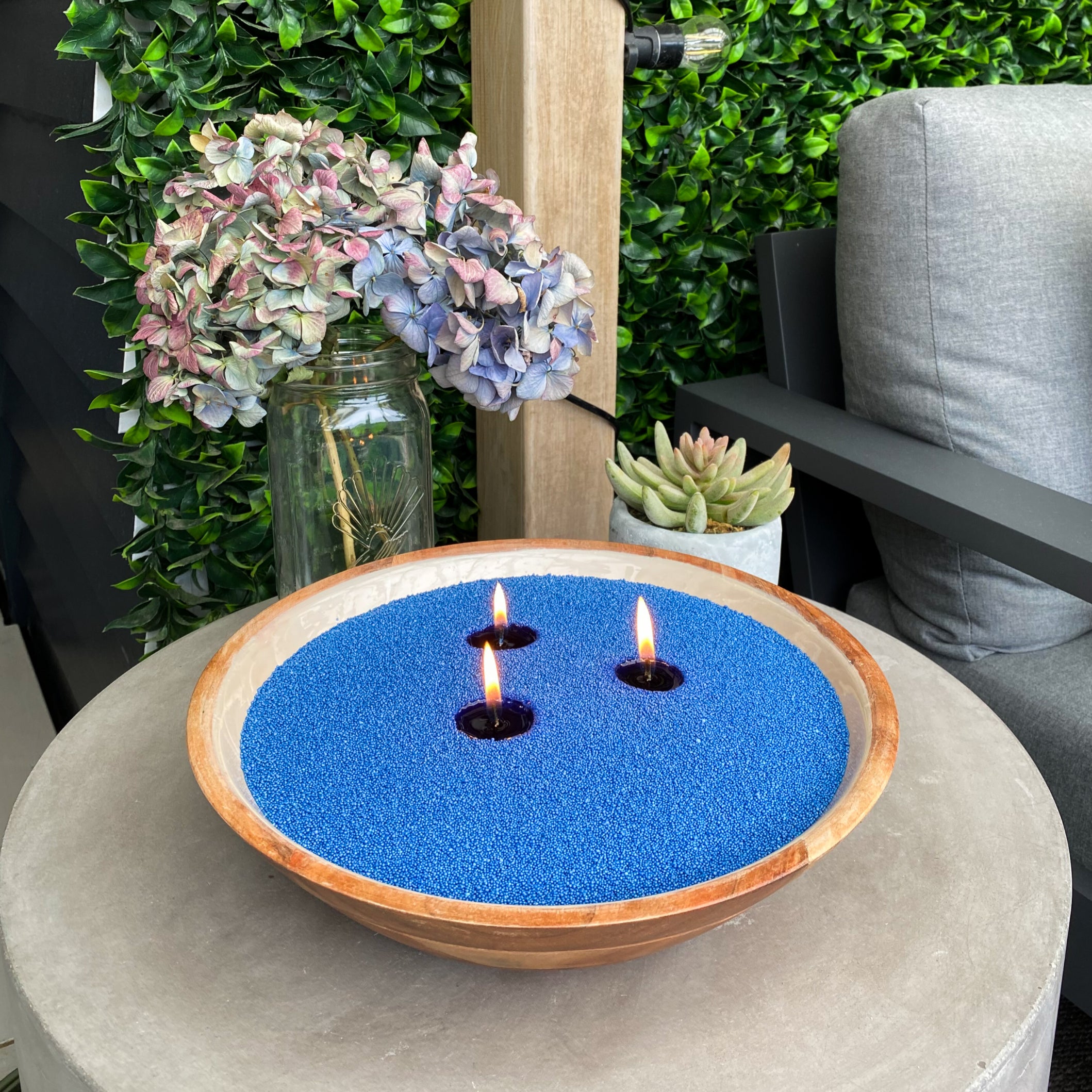 Bowl filled with Kai Iwi Blue Sand wax as an outdoor candle. Customised with three wicks. Clean burning and eco friendly 